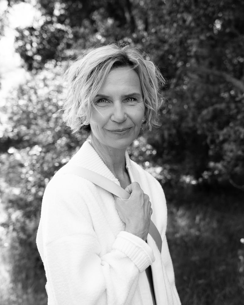 A quiet black-and-white portrait of Michelle in soft garden light